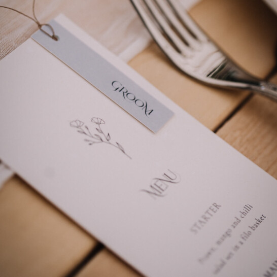 simple elegant wedding on the day stationery. Recycled paper floral menu with pale blue detail and fine paper twine