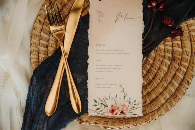 Hand-torn wedding menu on recycled cotton paper with silk ribbon at The Hall Barns Prestwold