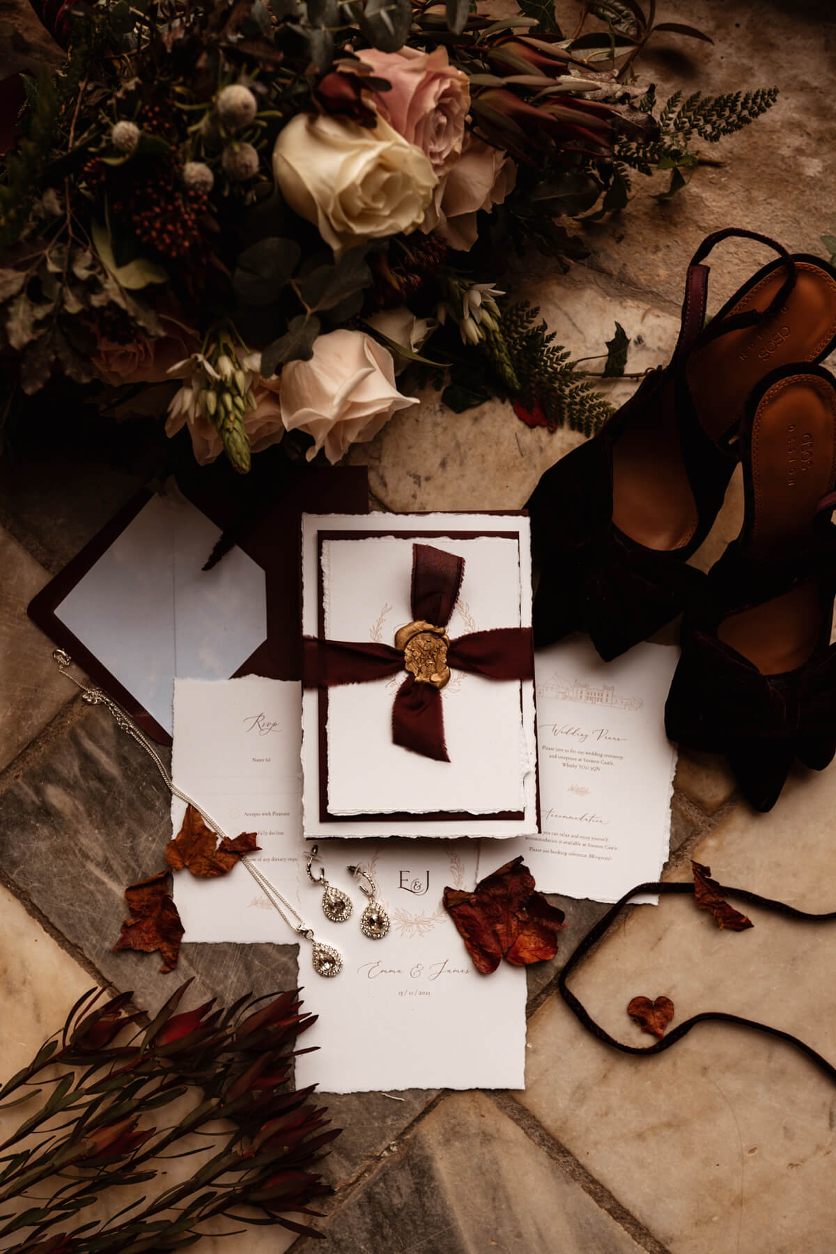 Wedding invitation with hand-torn paper, silk ribbon and wax seal