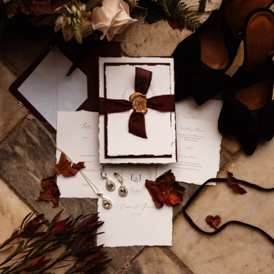 Elegant wedding invitations with hand torn edges, wedding illustration of Sneaton Castle Whitby. Plum ribbon with wax seal