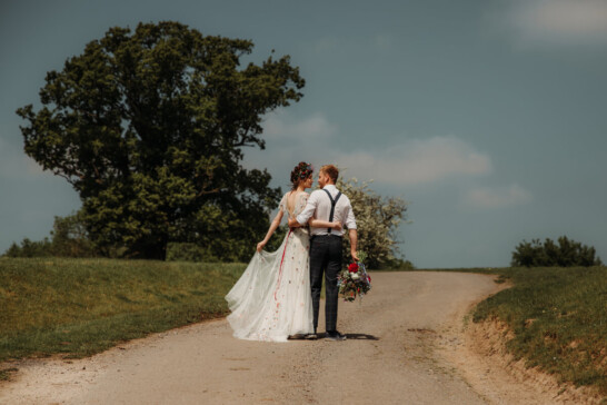 Eco wedding Bride and groom walking at The Hall Barns Prestwold