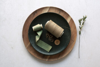 Sustainable weddings UK eco friendly wedding invitations. Stationery finishings on a plate silk ribbon, paper twine wax seal. Sustainable finishings