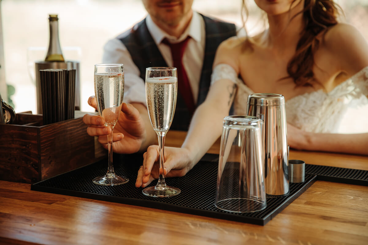Bride and groom sat at bar at adult only wedding