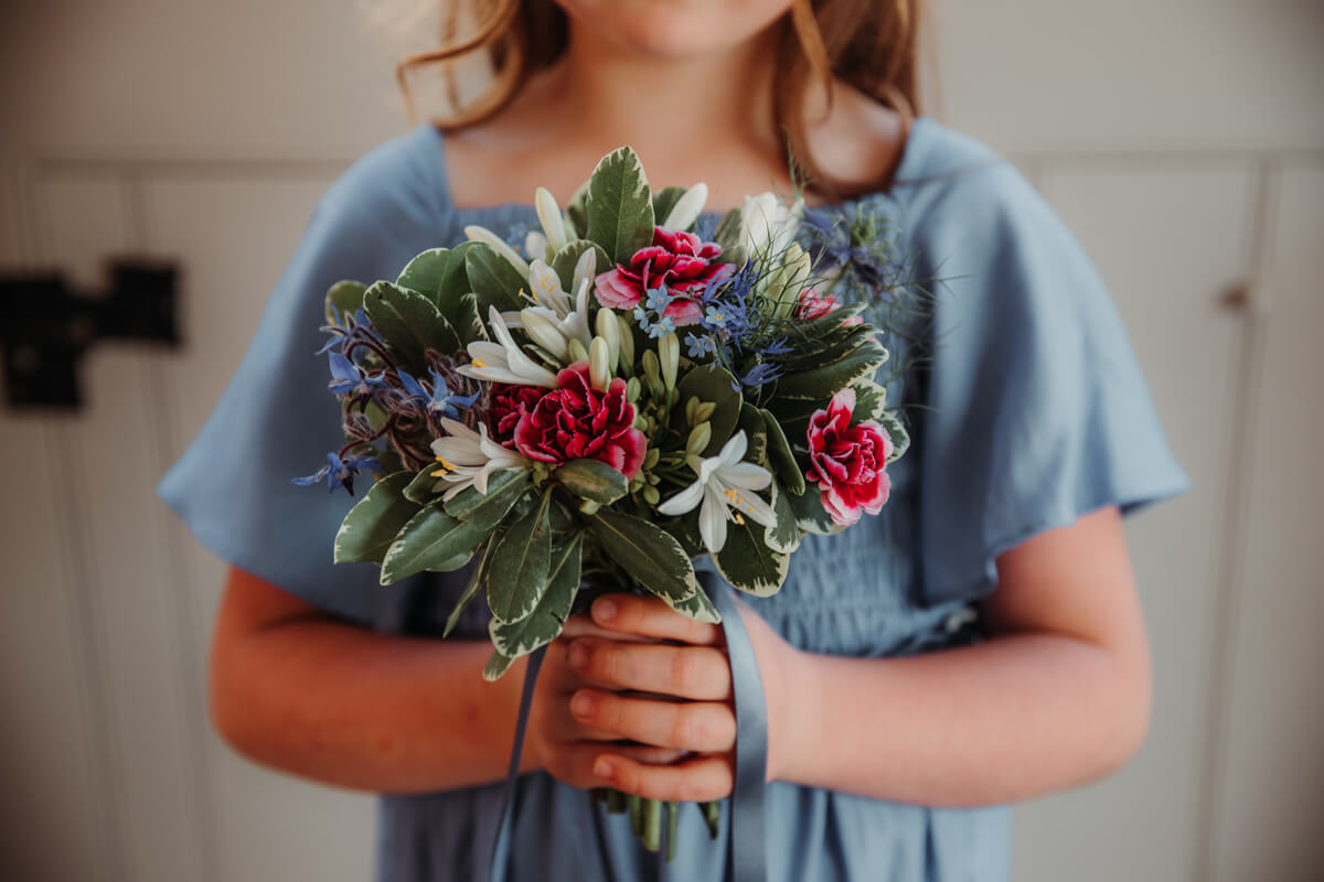 Flower girl at wedding holding posey at The Hall Barns Prestwold