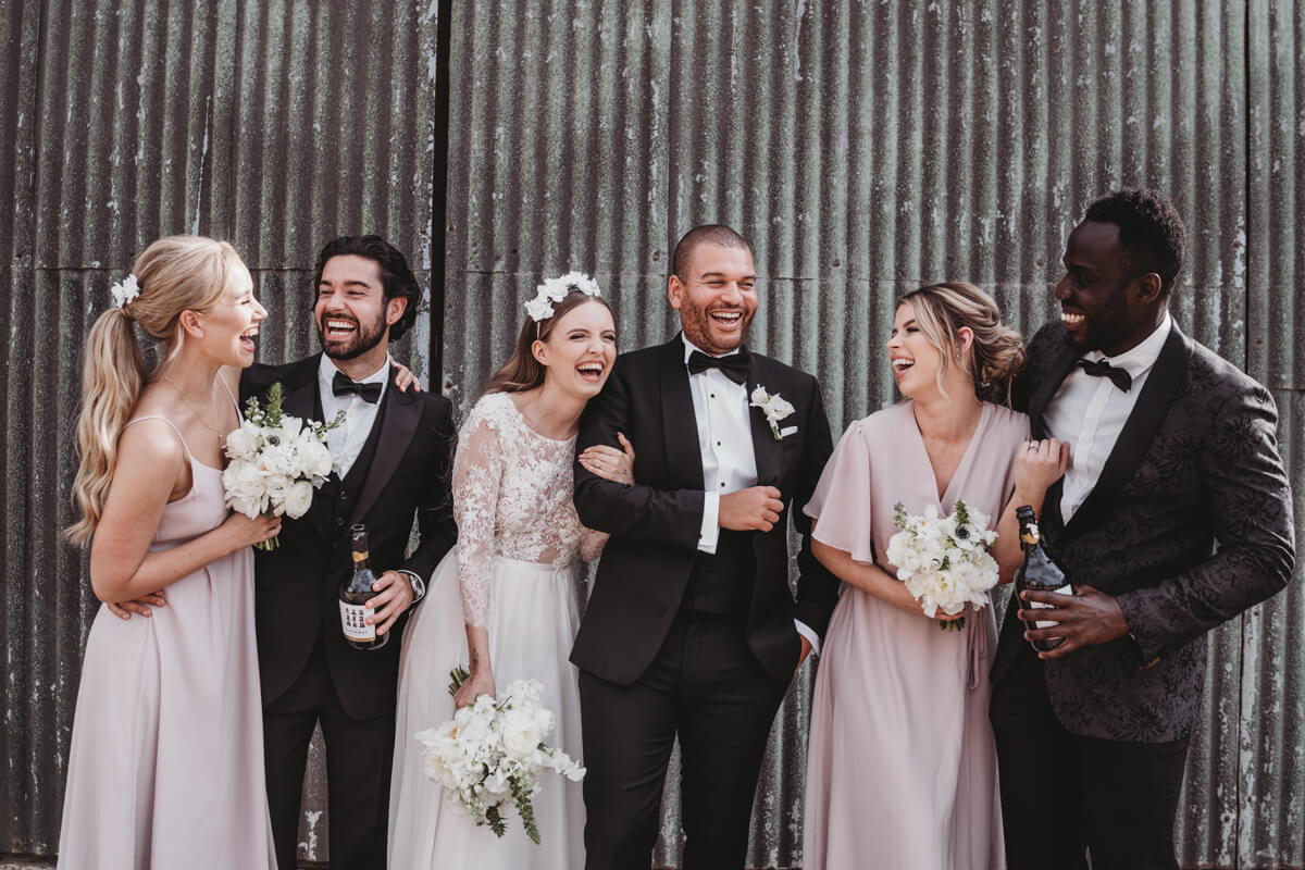 Wedding party enjoying wedding. How on the day wedding stationery can make your day run smooth