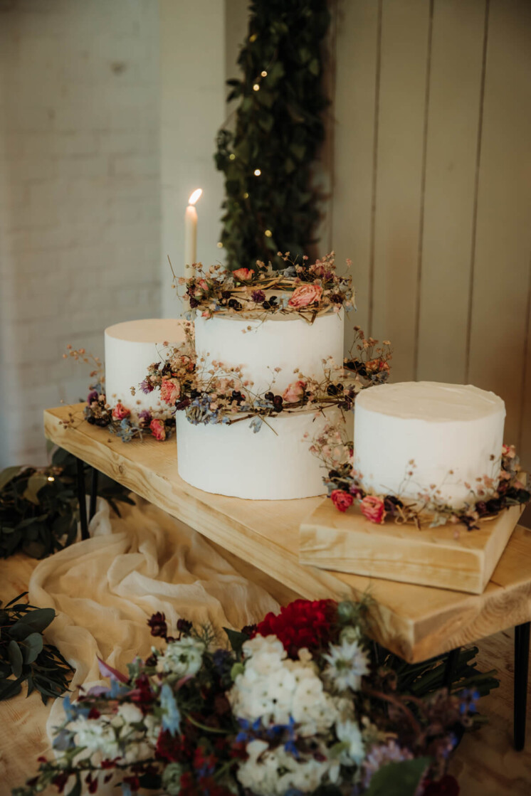 Wedding cake with dried flowers at barn wedding