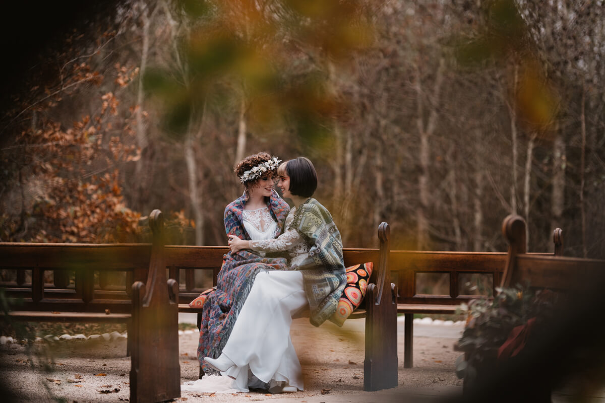 Brides wrapped in blanket at Autumn Wedding