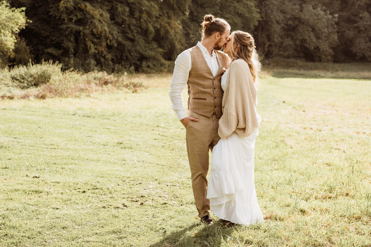 Gold hour wedding photograph of bride and groom in Autumn