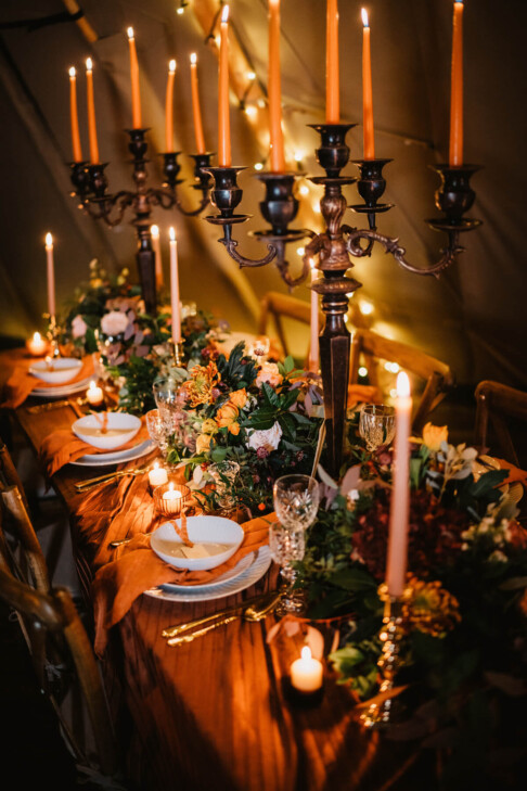 Forest themed wedding tablescape by candle light with seeded place names