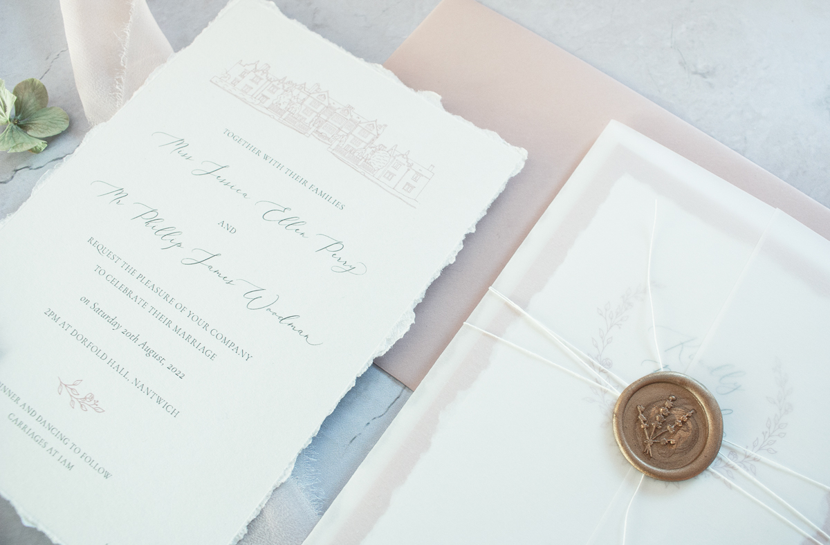 Dorfold Hall elegant blush pink wedding invitation. Hand torn edges, wax seal and white twine with vellum wrap