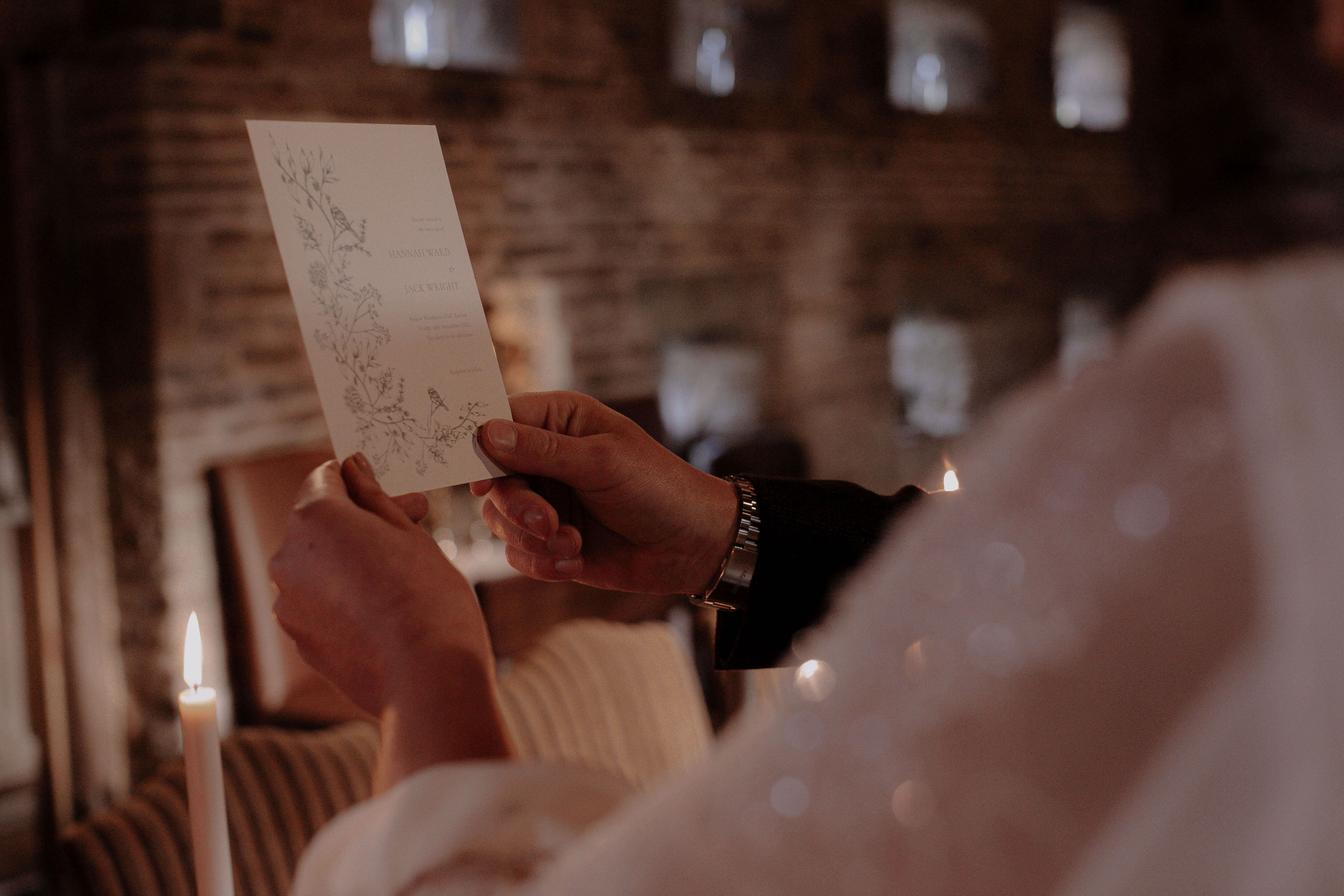 Bride and groom holding wedding invitation