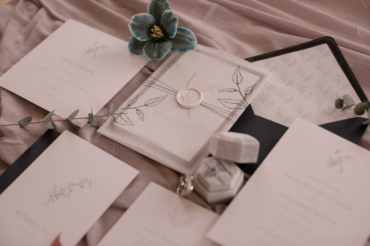 Navy blue floral wedding invitation. Flat lay at wedding.