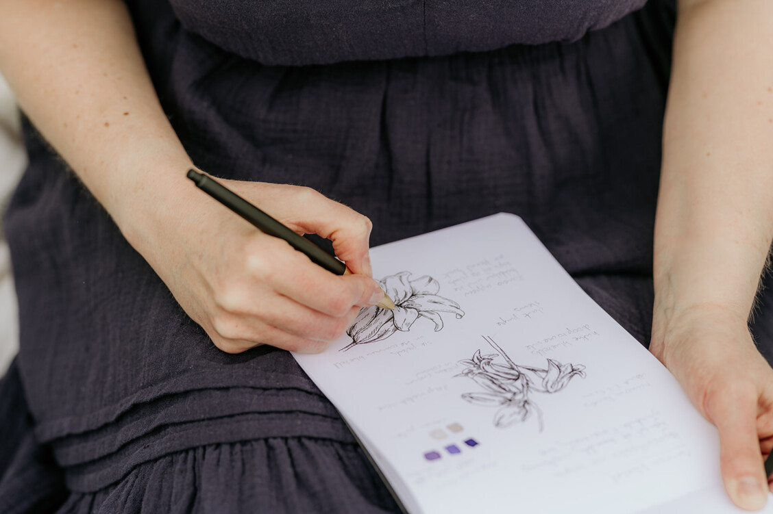 Sketchbook page featuring a hand-drawn study of a bluebell, capturing botanical details in pencil and ink